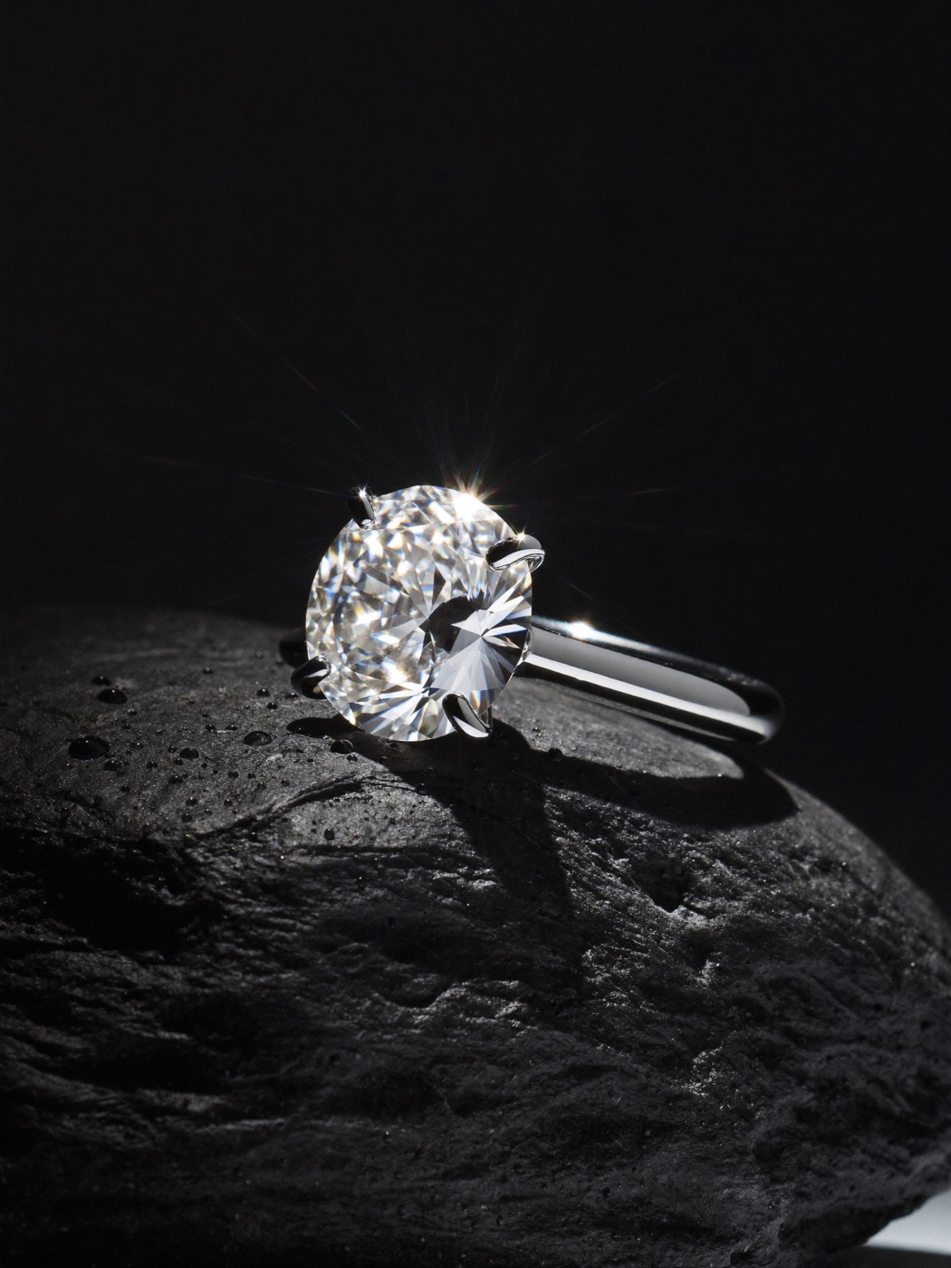 Diamond ring on wet black slate