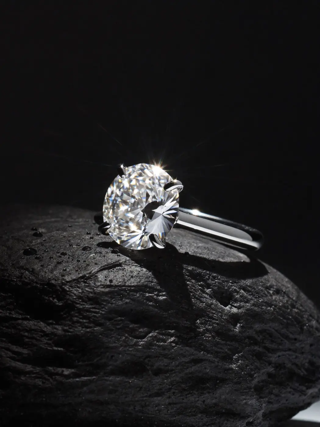 Diamond ring on wet black slate