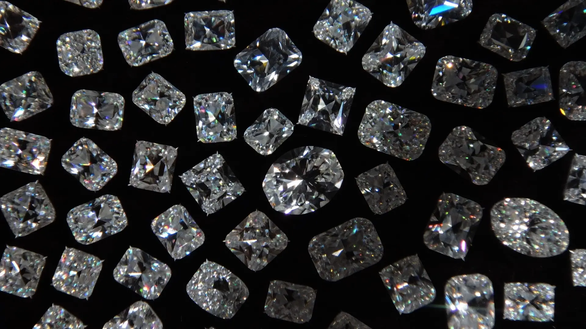 Loose diamonds scattered on black glass