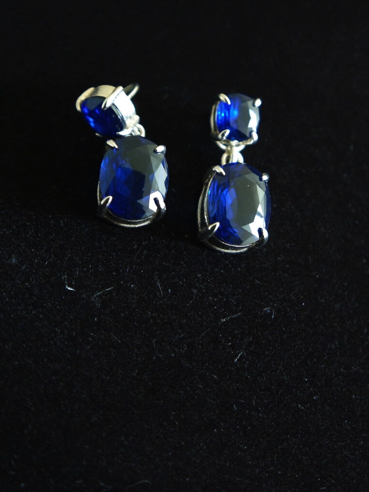Sapphire drop earrings on black velvet