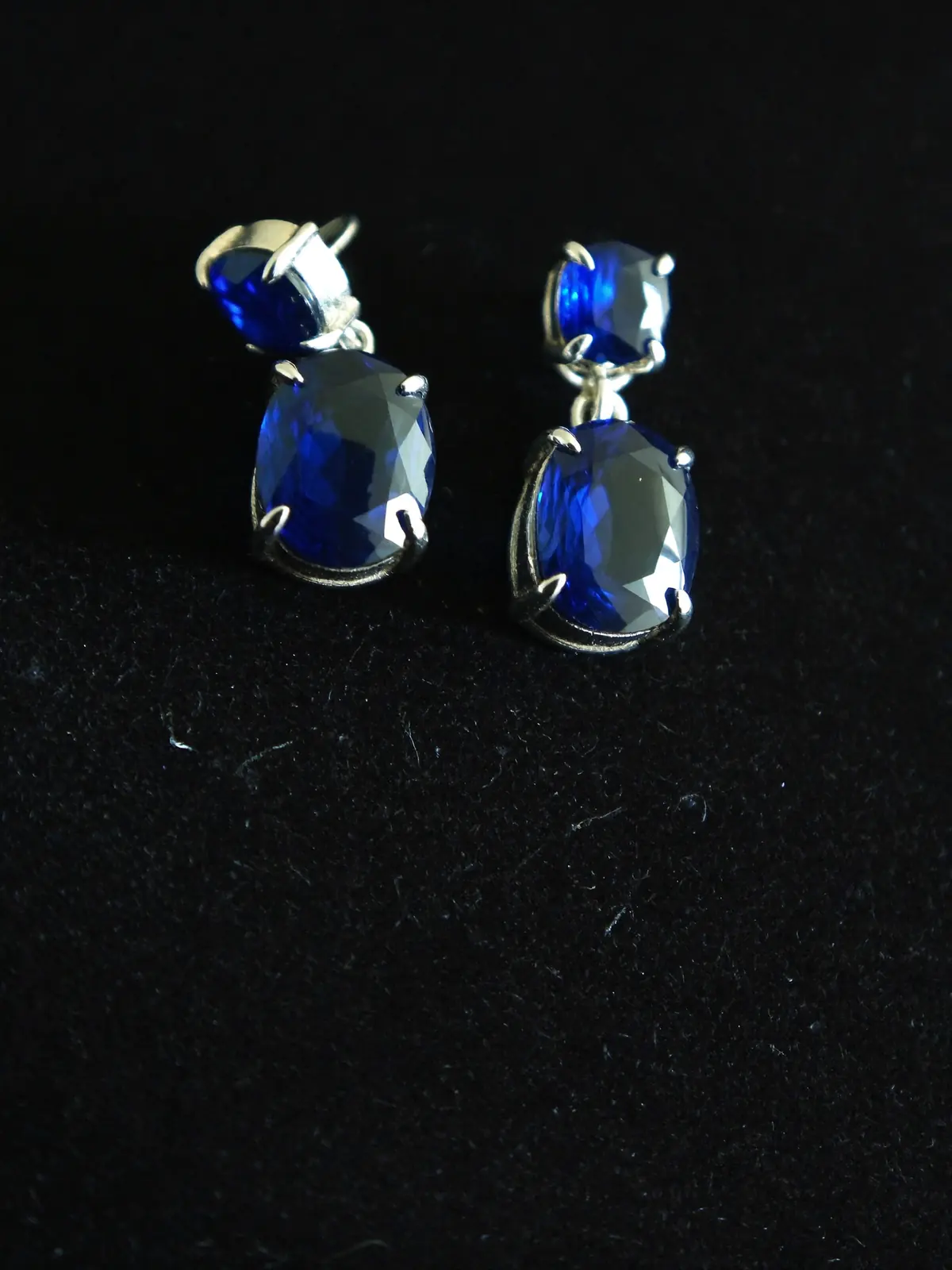 Sapphire drop earrings on black velvet