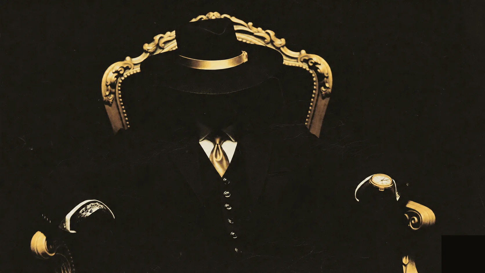 A man in a luxurious suit sits in a baroque armchair in the dark, his face hidden beneath the brim of his hat
